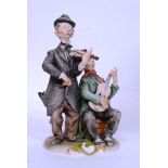 A vintage Capo De Monte figure of two tramps - with signature to base