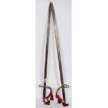 A pair of decorative early to mid-century brass and steel cavalry swords,
