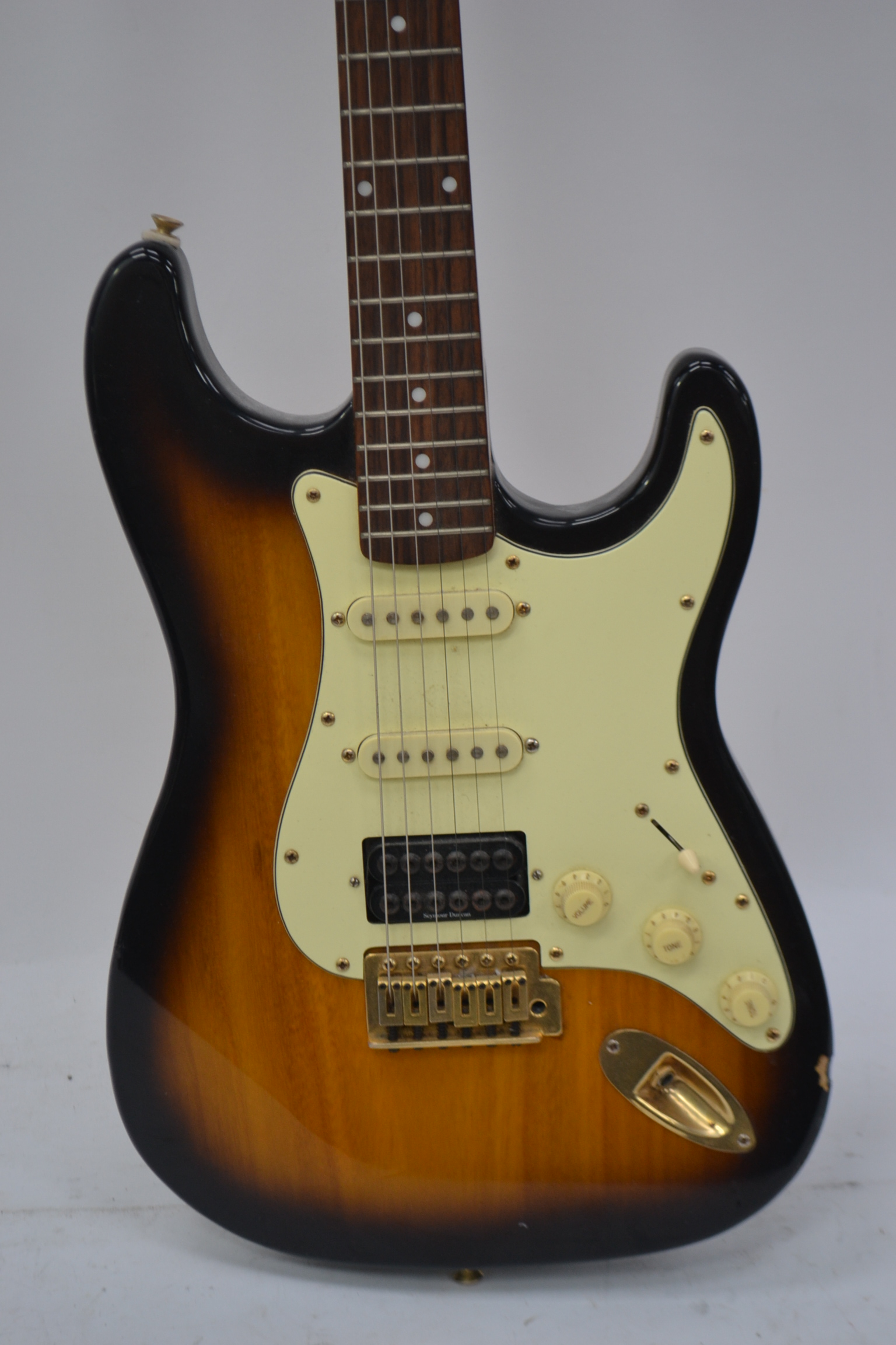 A two tone tobacco sunburst Tanglewood electric guitar.