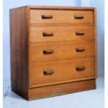 A 1950's Ernest Gomme - G-Plan oak straight four chest of drawers having pull original handles over