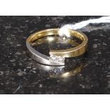 An 18ct gold 750 marked ladies diamond ring of contemporary cross over form with 2 cushion cut