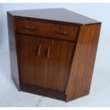 A 1970's G-Plan teak wood corner desk secretaire having fall front drawer pull put desk over