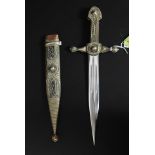 A decorative white metal filligree decorated ornamental dagger, with steel blade.