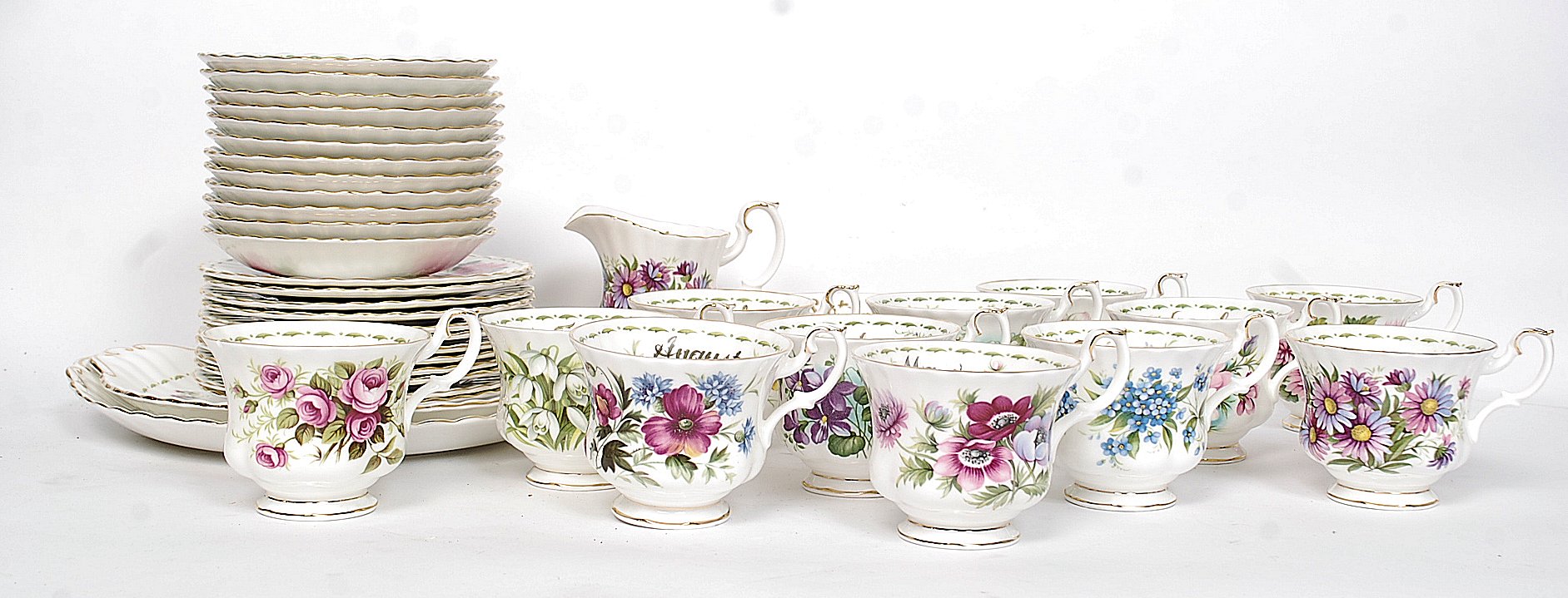 A Royal Albert ' Flower of The Month ' tea service comprising cups, saucers, plates,