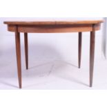 A 1970's G-Plan Chester range retro teak wood circular dining table raised on turned legs with