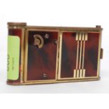 A 1930's Art Deco ladies musical - manicure combination compact having faux tortoiseshell and