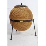 A Lloyd Loom Sputnik wicker linen basket, designed by Geoffrey Lusty,