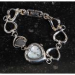A 925 silver white metal ladies wrist watch with heart shaped dial, with mother of pearl face.