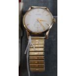 A vintage gentlemans Baume 17 Jewel 9ct gold hallmarked wristwatch set on a rolled gold flex strap.