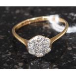 An 18ct gold and diamond ring with flower head having inset diamonds surrounding a star.