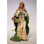 A ceramic figure of a maiden entitled 'T