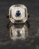 A 9ct gold hallmarked ring set with sapphires and 8 1pt illusion set diamonds in an Art Deco