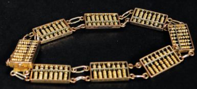 A 14ct gold ladies bracelet having an unusual articulated abacus linked design.