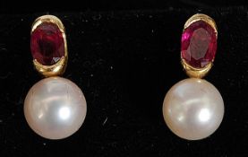 A pair of yellow gold ruby and pearl earrings.