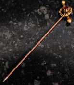 A 9ct gold and ruby set stick pin - hat pin having robe and bar mount stamped to verso 9ct.