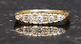 An 18ct gold and 5 stone ladies diamond ring.