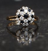 A 9ct gold hallmarked ring with CZ and Sapphire cluster. Weight 2g.