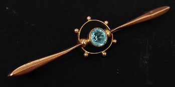 An early 20th century 9ct gold and aquamarine stone brooch having circular worked surround to the