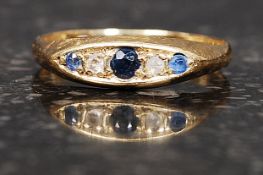 An 18ct hallmarked gold ring set with three saphires and 2 2pt diamonds. Total weight 2.8g. Size O.