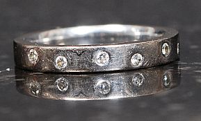 An 18ct white gold and diamond channel set eternity ring having inset 8 stones approx 8-10pnts