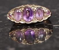 A 9ct gold hallmarked ring set with graduated amethyst stones. Weight 3.1g. Size J.
