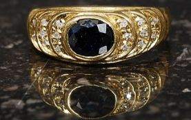 A ladies yellow gold sapphire and diamond ring. The central sapphire being round cut.