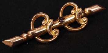 A 19th century 9ct gold Anglo Indian colonial bar brooch marked TB&Co to verso set with a claw