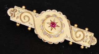 A Victorian 9ct gold and ruby bar brooch marked for Francis Barker (1819-1875). Total weight 2.8gms.