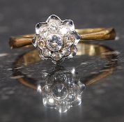 A ladies 18ct gold and diamond flower head ring.