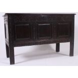 An 18th century carved oak peg jointed coffer - chest.