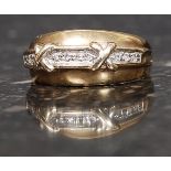 A 9ct gold hallmarked ring set with 10 x 1pt diamonds with a twin cross motif. Size L. 3.