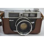 A leather cased vintage 35mm camera by Ricoh with original carry straps

UK,