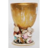 A late 19th century / early 20th century Meissen style ceramic cherub cup. Marks to base.