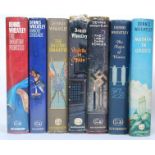 A collection of twelve Dennis Wheatley first edition hardback book novels with dust jackets.