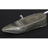 An early 19th century pewter snuff box in the form of a shoe with hinged top having chase