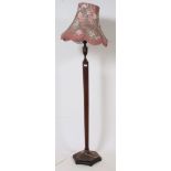A good 1930's Art Deco oak standard lamp of hexagonal form complete with shade.