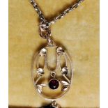 A 9ct gold gold box chain and ruby garnet stone pendant, circa early 20th century Art Nouveau.