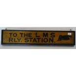 A vintage wooden painted railway sign with notation for LMS - Railway Station set in black font on