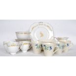 An Art Deco hand painted part tea service along with a part tea service titled ' Fantasia '