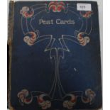 A vintage album containing a collection of early 20th century greeting cards to include silk,