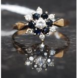 A 9ct gold, diamond and sapphire flower head ring.