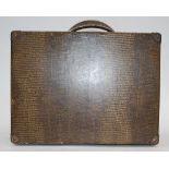 A vintage 1920's Decca portable gramaphone in faux crocodile skin suitcase.