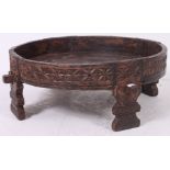 An early 20th century Indian - oriental opium cartwheel table - coffee table stool of rustic form