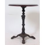 A Victorian cast iron base tavern table, with round top standing on cast iron base with four feet.