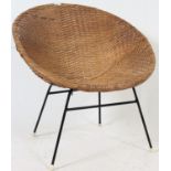 A retro vintage wicker chair on tubular metal supports.