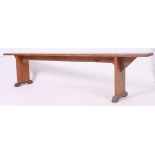 A 19th century French provincial pine refectory pig bench having a planked top with angled supports