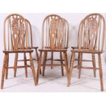 An excellent set of 6 mid century Windsor wheelback country dining chairs raised on turned legs