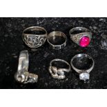 A collection of 5 silver earrings to include skull, symbols, claw mounted stone set,