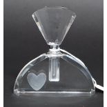 An art Deco style perfume bottle having an off set heart to the main body,