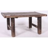 A Chinese pine opium - tea table of rustic form raised on sqaured legs with planked top